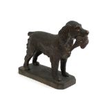 Louis LeJeune - A bronze metal car mascot of a Springer Spaniel carrying a pheasant, marked LE to