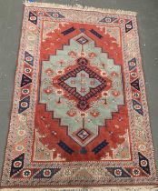 Red ground heriz style rug with blue lozenge, approx. 185x123cm
