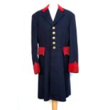 A hunt coat in navy with red velvet detail, tailored by Henri Juliot, La Membrolle', the buttons