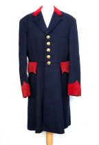 A hunt coat in navy with red velvet detail, tailored by Henri Juliot, La Membrolle', the buttons