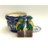 A pair of colourful Chinese decorative foo dogs; saucer; and planter