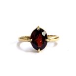 A gold ring set with a garnet, unhallmarked but tests as 18ct, size P 1/2, 4g