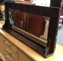 A carved oak mirror with bevelled glass, 120x51cm
