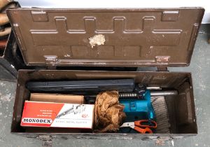 A vintage metal ammo box, containing a Black & Decker drill stand, sheet metal cutter, etc