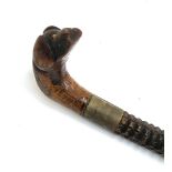 Folk art interest: a naively carved walking stick with dog mask handle, 83cmL