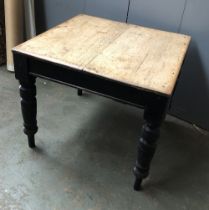 A Victorian pine kitchen table with black painted base, 83x85x72cmH