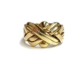 A heavy gold puzzle ring, unmarked but tests as 18ct, size R, 10.8g