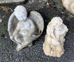 Two composite stone cherubs, the larger 34cmH