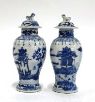 A pair of small Chinese blue and white vases with lids surmounted by foo dogs, marks to base, 15.