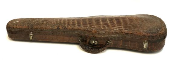An American crocodile leather violin case, green velvet interior, bears label for Cyrus Gamble;