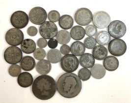 A quantity of pre 1947 silver coins to include George III crown, approx. weight 250g
