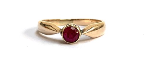An early 20th century gold ruby solitaire ring, unmarked but tests as 14ct or higher, size J, 2.2g