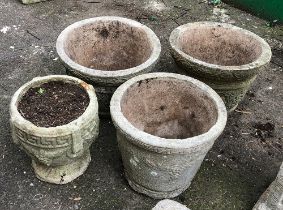 Four composite stone circular planters, the largest 33cmD