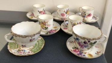A set of five Royal Crown Derby hand painted floral cups and saucers, together with a pair of