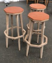 Interior design interest: a set of three hand made plywood stools, orange stained octagonal seats,