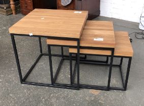 A nest of three oak topped and fabricated metal occasional tables, the largest 50x50x50cm