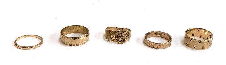 A lot of five 9ct gold rings, one hand engraved 'I love my wife forever' inside, a buckle ring