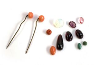 A small quantity of loose gemstones to include three garnet cabochons; opaline glass; coral etc