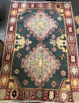 A kilim rug (af), two central hooked lozenges on a turquoise ground, 175x120cm