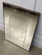 A contemporary wall mirror, made up of nine bevelled plates, 95x70cm