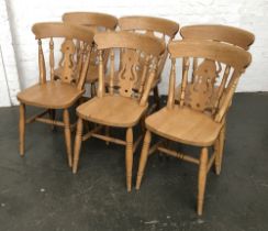 A set of six beechwood splat back kitchen chairs