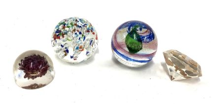 Two art glass paperweights, each approx. 10cmD, together with two resin paperweights, one set with