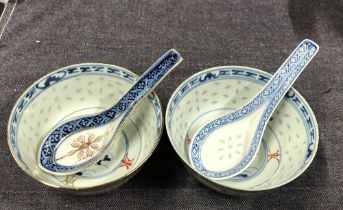 A near pair of Chinese 'rice' bowls and two spoons; together with a small famille rose bowl, 11cm