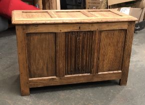 An oak three panel coffer, with central linenfold carving, 92x43x58cmH