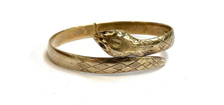 A gold plated silver snake bangle with garnet eyes, hallmarked for London, 1965, 25.8g