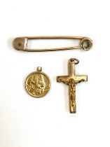 A 9ct gold crucifix and St.Christopher, gross weigh approx. 2g; together with a yellow metal stock