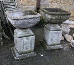 A pair of composite stone urn planters on plinths, approx. 88cmH