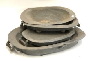 Four large pewter platters, the largest approx. 65cmW