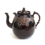 An oversized treacle glazed teapot and cover, bearing the Royal Crest in relief, 26cmH