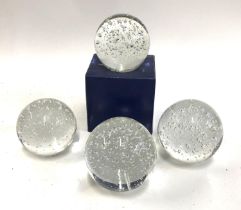 Four glass paperweights, each 9cmD