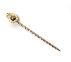 A gold Royal Marines stick pin, unmarked, the stick testing as 9ct and the terminal testing as