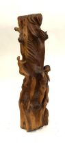 A carved yew wood sculpture of figures climbing a tree trunk (af), 72cmH