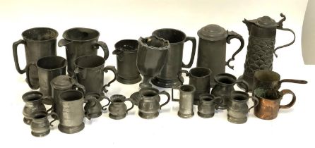 A large quantity of pewter tankards and measures to include quarts, pints, half gill, gill etc,