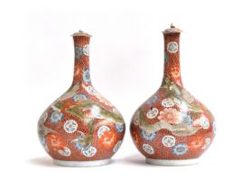 A pair of large Japanese Kutani bottle bottle vases and covers (af), dragon on an orange and white
