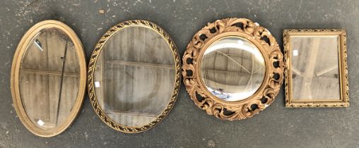 A lot of four gilt style mirrors: two oval, one small rectangular, and one with scrolling pierced