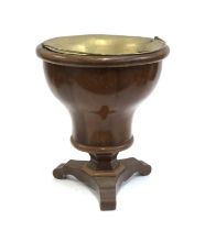 Interior design interest: A turned mahogany urn on a triform base with brass liner, 43cmH