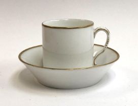 A French Nast porcelain teacup and saucer, heightened in gilt, marked to base, the cup 6cmH, the