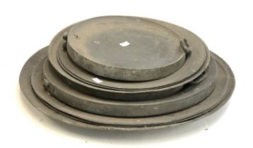 A quantity of pewter chargers, the largest approx. 55cmD