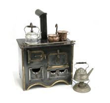 A vintage miniature enamel and brass range cooker, with gas fitting, 32cmW, with miniature kettle,