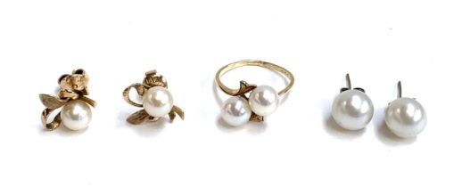 A 14ct gold pearl crossover ring, size O, 2.8g; together with a pair of 14ct gold and pearl stud