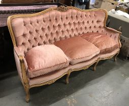 A Louis XV style continental button back sofa with carved frame