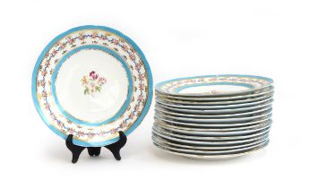 A set of 16 Coalport plates, light blue border heightened in gilt, central floral spray