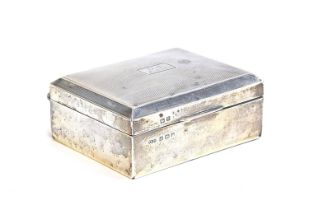 An engine turned silver cigarette box by Smith & Bartlam, Birmingham 1923, the top monogrammed G.J.,