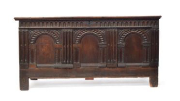 A very large 18th century oak coffer, the front of three domed panels, with panelled back and sides,