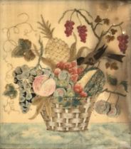 An early 19th century needlework depicting a songbird perched on a basket of fruit, containing