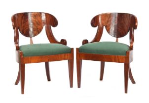 A pair of mahogany Russian Biedermeier klizmos style side chairs, stuffover upholstered seats,
